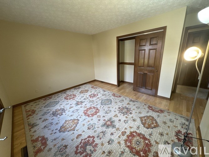 A room with a rug and a door.