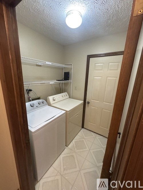 A small laundry room with a washer and dryer.