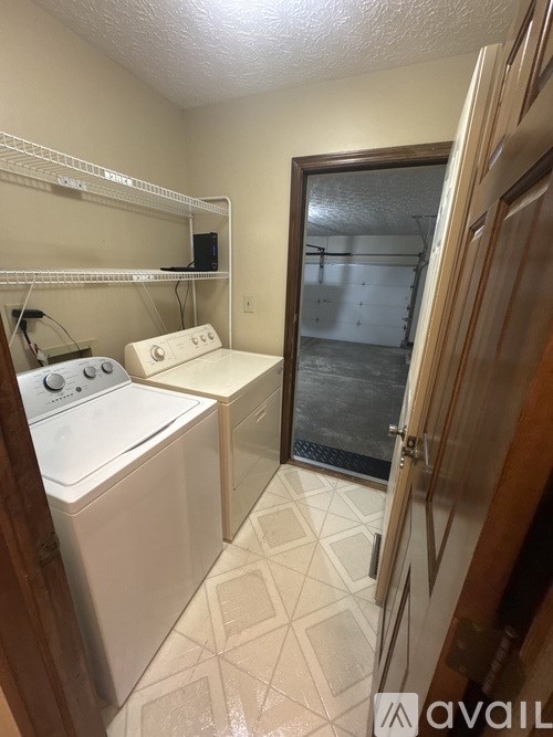 A small laundry room with a washer and dryer.