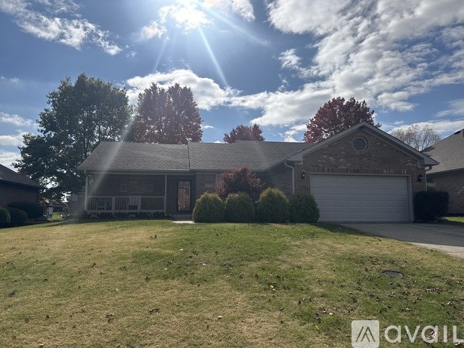 A house with a garage and a driveway in front of it.