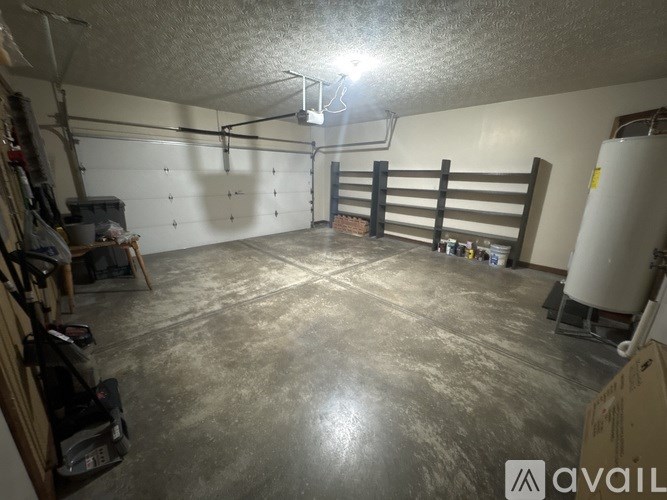 A large, empty garage with a concrete floor and white walls.