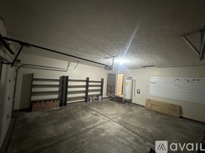 A spacious garage with a concrete floor and a ceiling with a light fixture.
