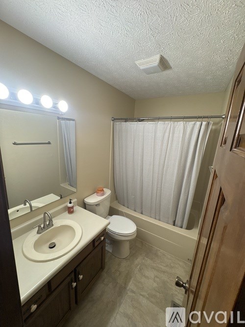 A bathroom with a sink, toilet, and shower.