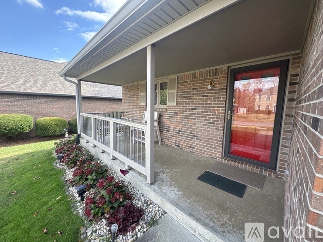 A house with a red door and a white porch.