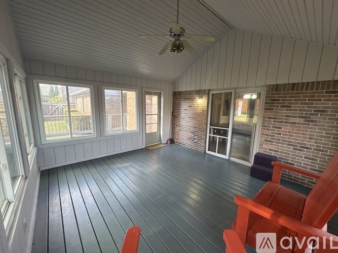 A room with a wooden floor and a ceiling fan.
