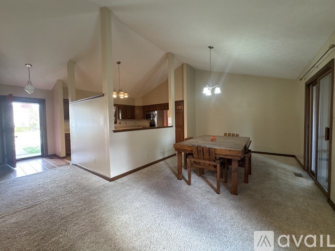 A dining room with a table and chairs is available for rent.