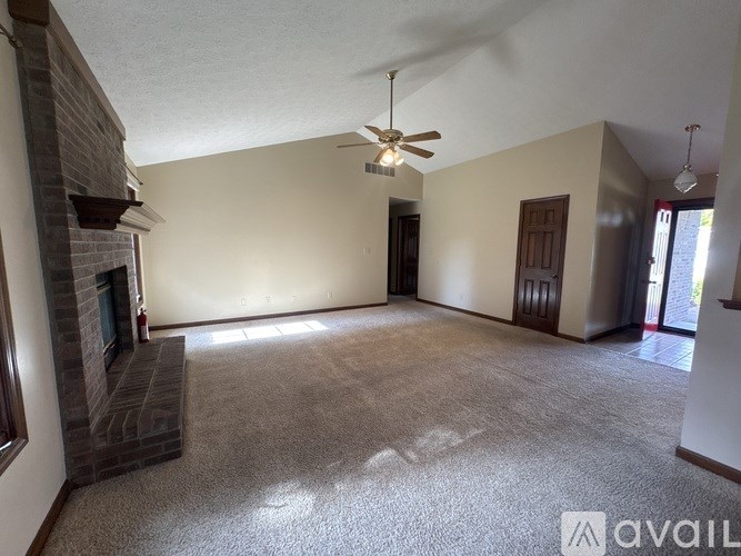 A living room with a fireplace and a carpet.