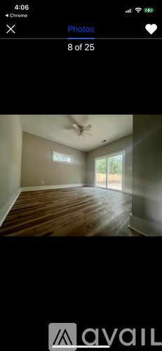 A room with wooden flooring and a ceiling fan.
