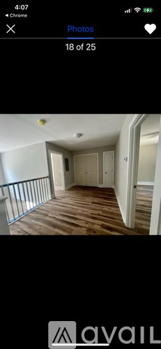 A room with wooden flooring and white walls.