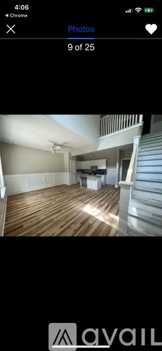 A room with wooden flooring and a staircase.