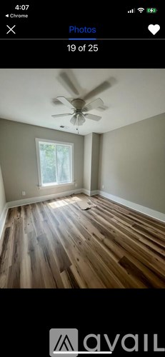 A room with wooden flooring and a ceiling fan.