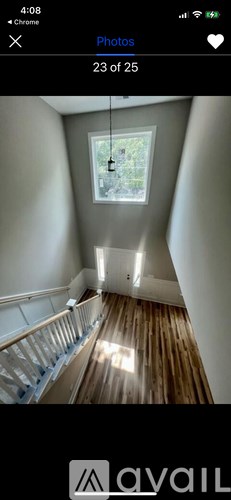 A room with wooden floors and a skylight.