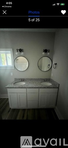 A bathroom with two sinks and two mirrors.