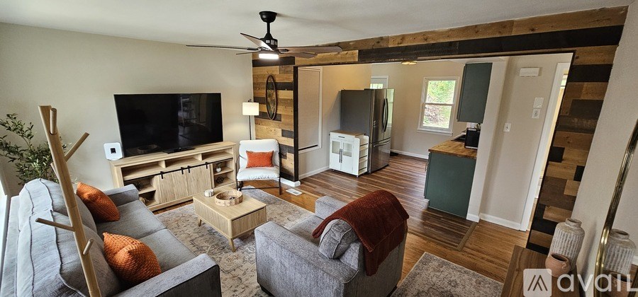 A living room with a grey couch and a wooden coffee table.