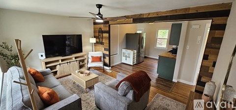 A living room with a grey couch and a wooden coffee table.