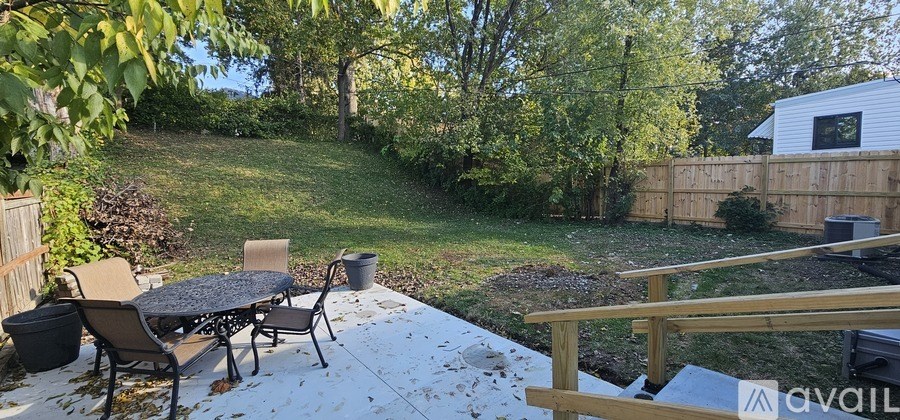 A backyard with a table and chairs.