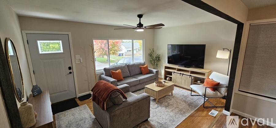 A living room with a grey couch and a television.