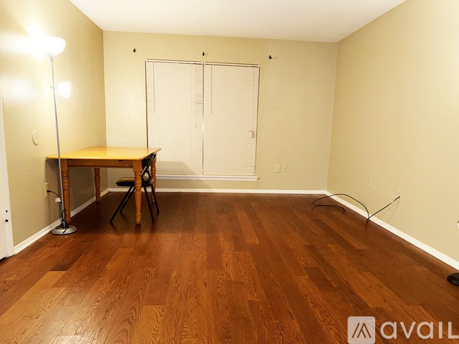 A room with a wooden table and chairs.