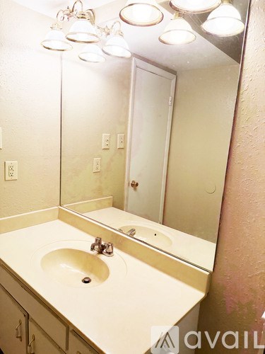 A bathroom with a sink and mirror.