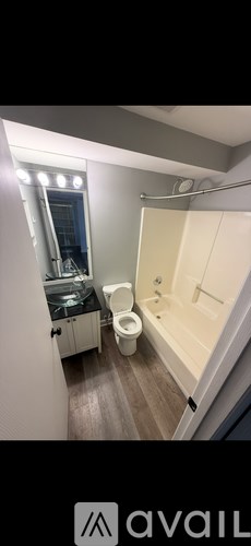 A bathroom with a toilet, sink, and bathtub.