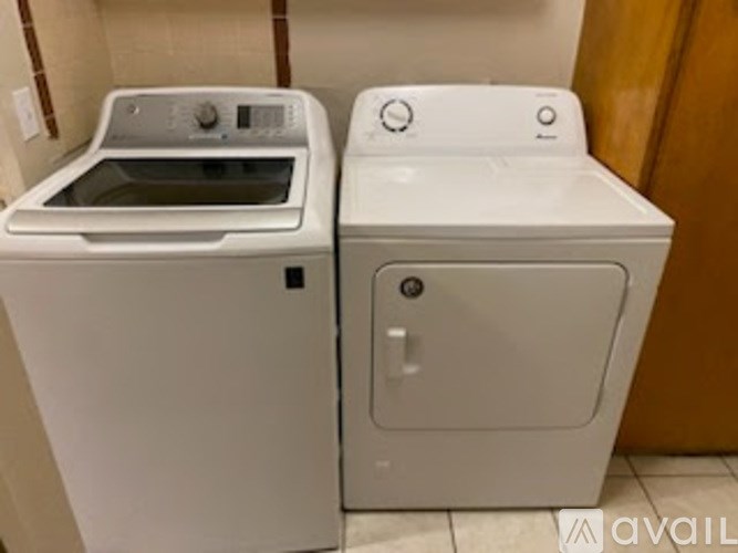 A white washing machine and dryer are available for use.