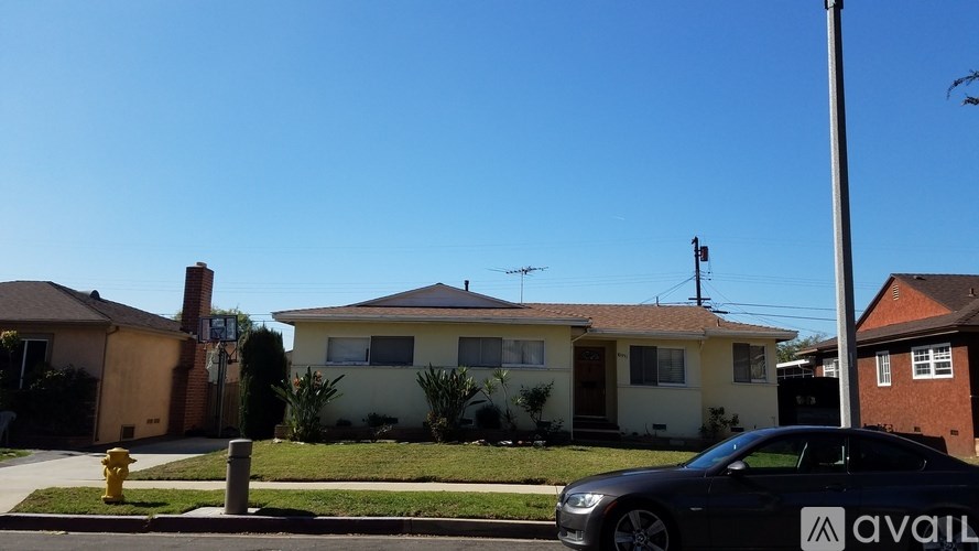 A black car with the word "available" written on the side is parked in front of a house.