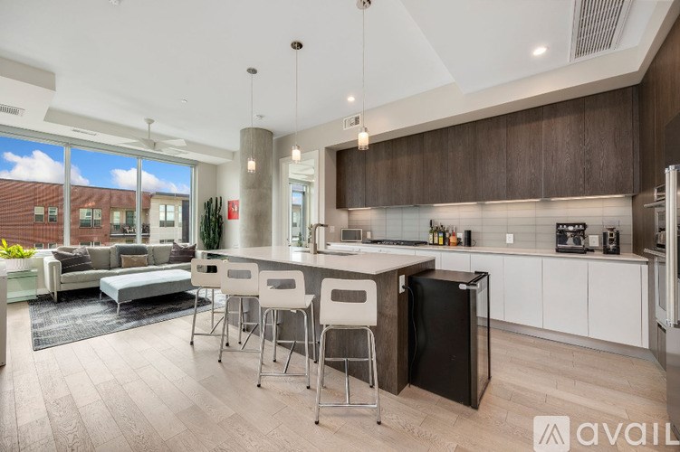 A modern kitchen with a dining table and chairs.