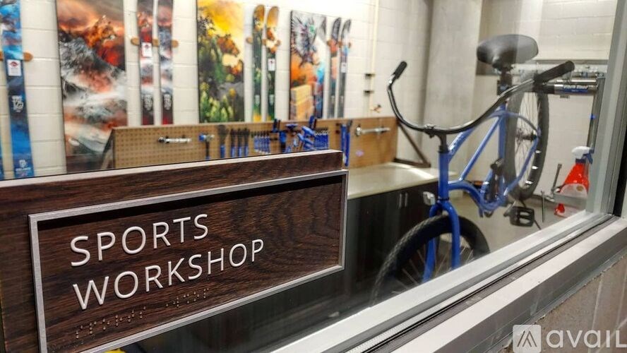 A sign that says Sports Workshop is on a window sill.