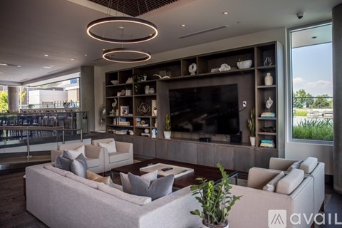 A modern living room with a large couch and a television.