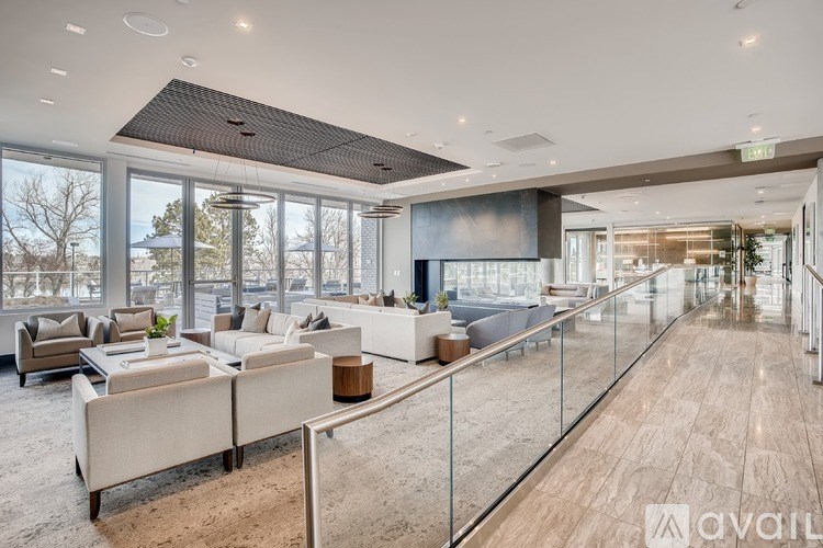 A spacious living room with a glass railing and a large window.