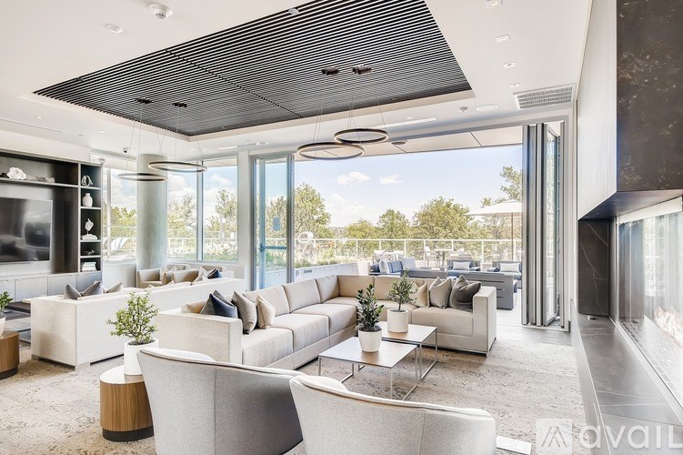 A modern living room with a large window and a flat screen TV.