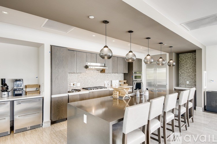 A modern kitchen with a long table and chairs.