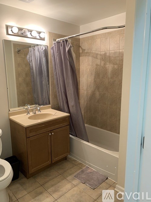 A bathroom with a sink, toilet, and shower.