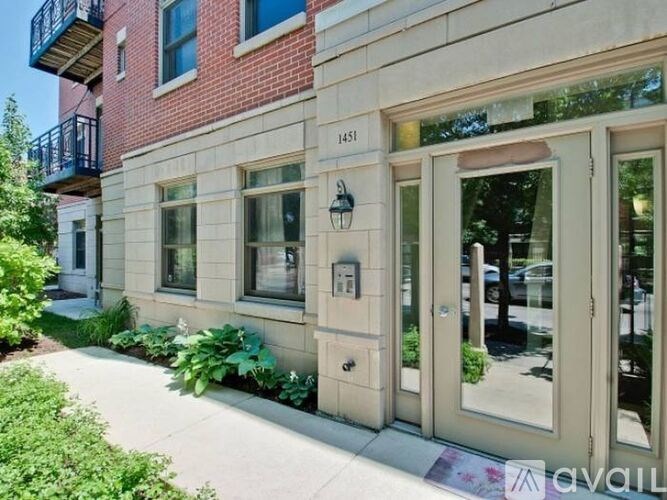 A red brick building with a balcony on the second floor.