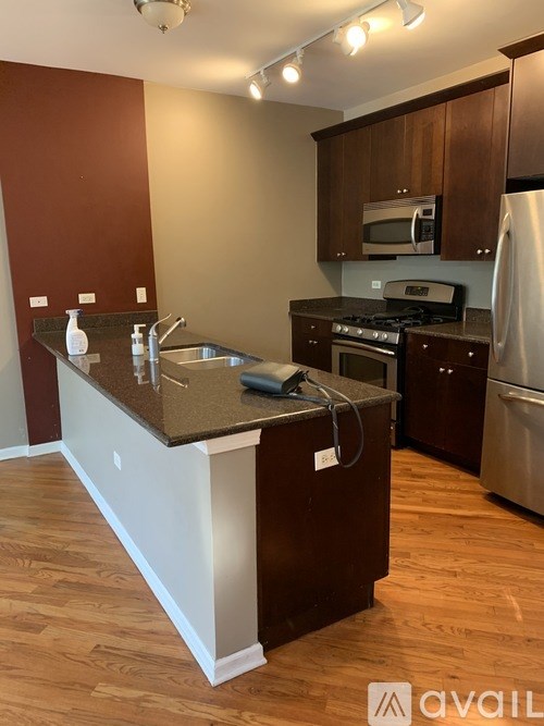 A kitchen with brown cabinets and a white island.