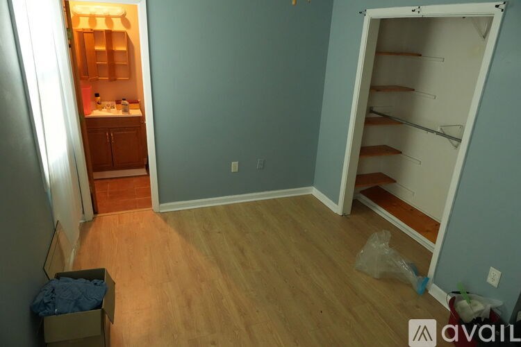 A room with a blue wall and a white door is shown.