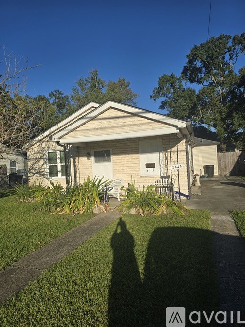 A house with a shadow of a person in front of it.