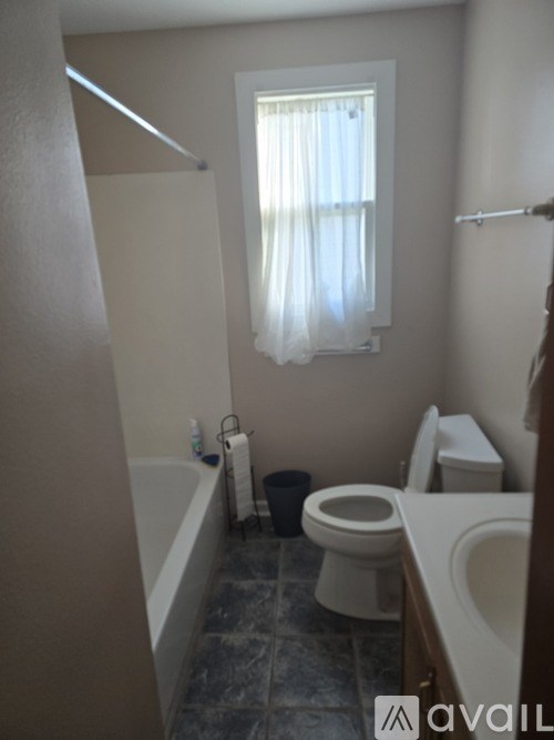 A bathroom with a toilet, sink, and bathtub.