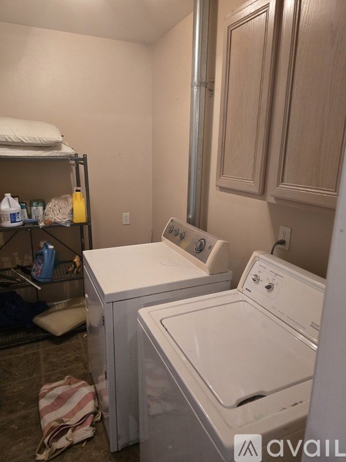 A small laundry room with a washer and dryer.