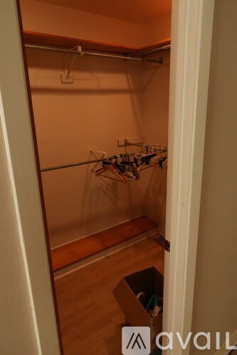 A room with a ceiling fan and a couch with a floral curtain.