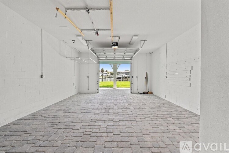 A long hallway with a brick floor and white walls.