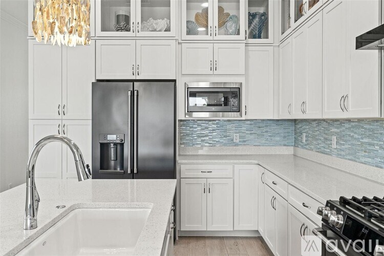A kitchen with a sink, refrigerator, and oven.