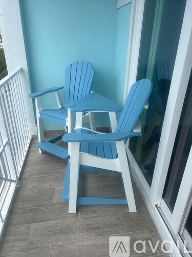 A blue and white Adirondack chair sits on a porch.