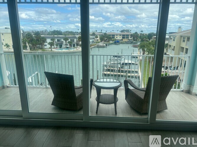 A balcony with a table and chairs overlooking a marina.