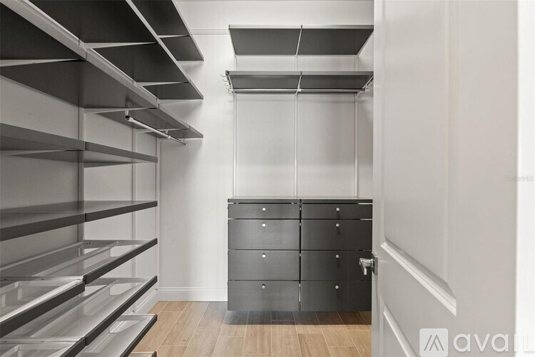A kitchen with a drawer unit and shelves.