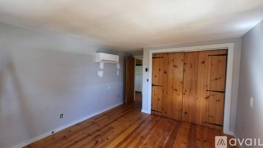 A room with wooden floors and a white door.