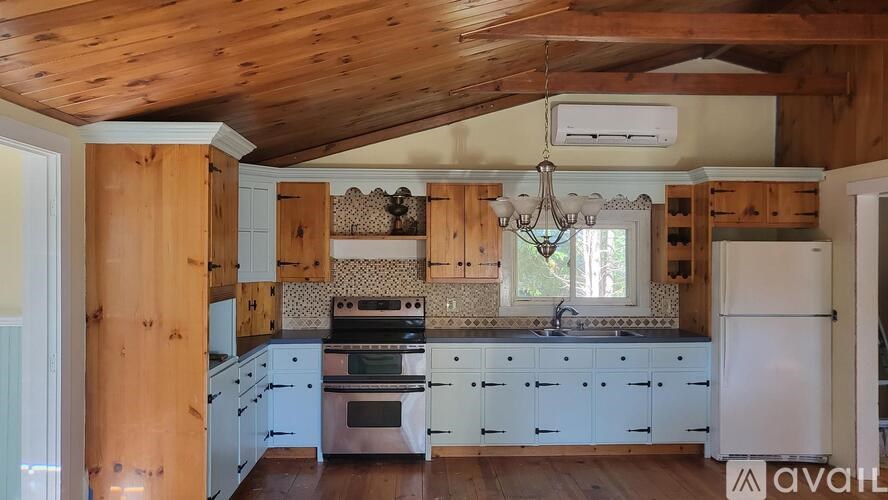 A kitchen with wooden cabinets and a white refrigerator.