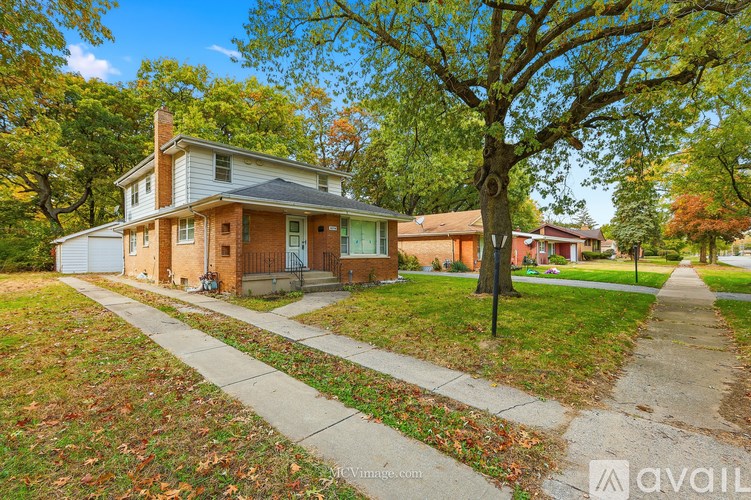 A house with a tree in front of it.