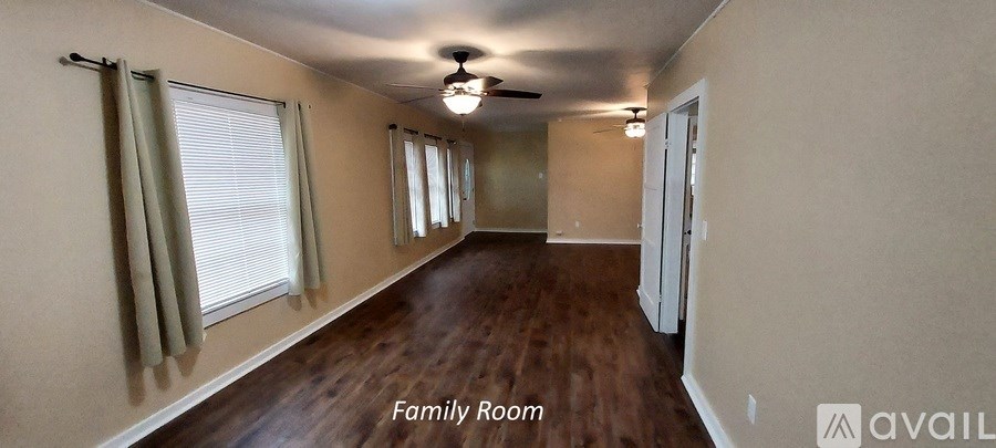 A long hallway with a sign that says "Family Room".