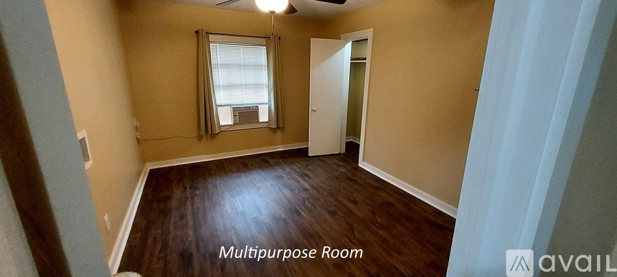 A room with wood flooring and a window is available.